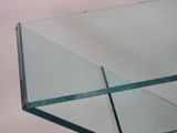 a glass table with a glass top on a white background