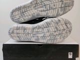 the soles of a pair of shoes are on top of a box