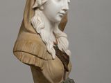 statue of a woman with a hood on her head