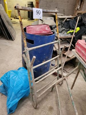 a pile of trash in a warehouse with a sign on it