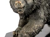 a statue of a bear on a black marble base
