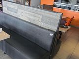 des tables et des bancs dans un restaurant aux murs orange et au sol carrelé