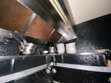 many pots and pans on the shelf in the kitchen