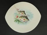 a plate with two fish on it on a table