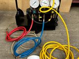 an image of a couple of air compressors with hoses and gauges