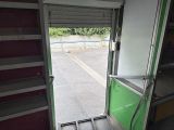 an open door leading to a parking lot with a parking lot in the background
