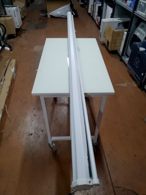 a picture of a white table in a warehouse