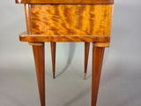a small wooden table with a drawer on it