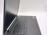 a black laptop with a black keyboard on a white surface