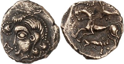 a silver coin with an image of a man and a horse