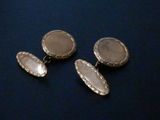 three silver plated cufflinks on a blue background