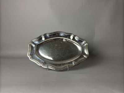 une photo d'une assiette en argent posée sur une table, sur fond blanc