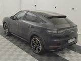 the porsche cayen is parked in a garage with a checkered floor