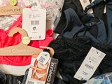 a pile of underwear and a hanger on a table