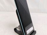 the back of a cell phone with a broken screen sitting on top of a stand