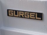a close up of a badge on the back of a white truck