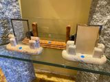 a glass table with a mirror and some items on it