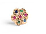 a close up of a gold ring with multi colored stones