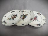 three plates with floral designs are stacked on top of each other