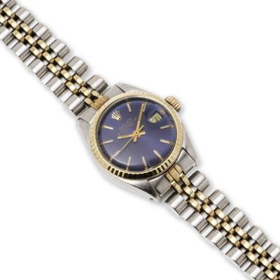 a close up of a wrist watch with a blue dial