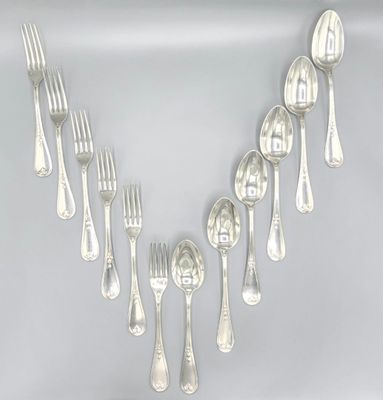a lot of silver spoons and forks on a table