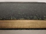 an old book that is sitting on a table