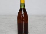 a brown bottle with a yellow cap sitting on a table