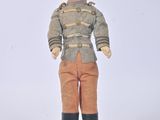 a small doll that is standing on a white surface