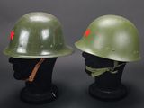 two green helmets with red stars on them sitting next to each other