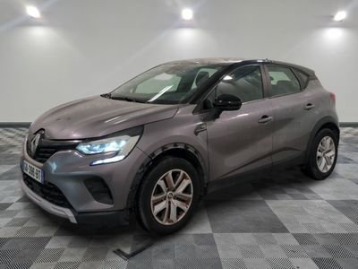 the grey car is parked on a checkered floor in a garage