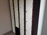 many lockers in a room with a lot of doors