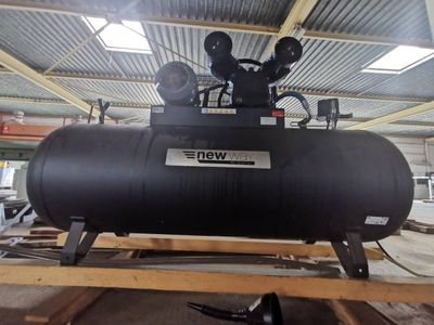 a black tank sitting on top of a pallet in a warehouse