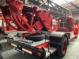 a red fire truck that is parked in a garage