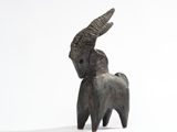 a small statue of a goat with horns on it ' s head