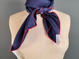 a mannequin torso with a blue and red scarf on it