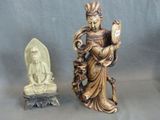 a statue of a woman holding a book and a statue of a statue of a buddha