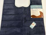 the back of a blue bath mat with a tag on it