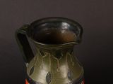 a vase that is sitting on a table with a black background