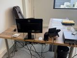 a desk with two computers and a laptop on it