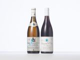 two bottles of wine sitting next to each other on a table