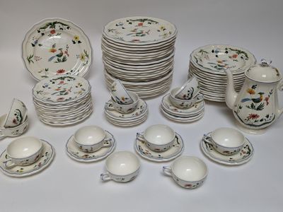 a lot of plates and cups and saucers on the table