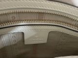 the inside of a white purse with a tag on it