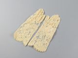 pair of ivory lace gloves on a gray surface