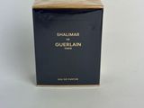 a close up of a box of perfume on a white surface