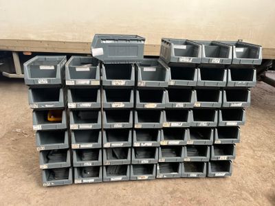 many bins stacked on top of each other in the garage