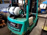 a forklift truck that is parked in a garage