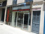 a store front with a red sign on the front of it