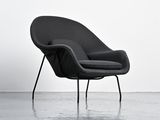 an image of a black chair sitting on top of a cement floor