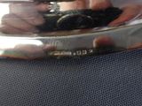 a person that is holding a silver object in their hand