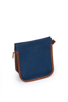 a small blue bag with a brown handle on a white background